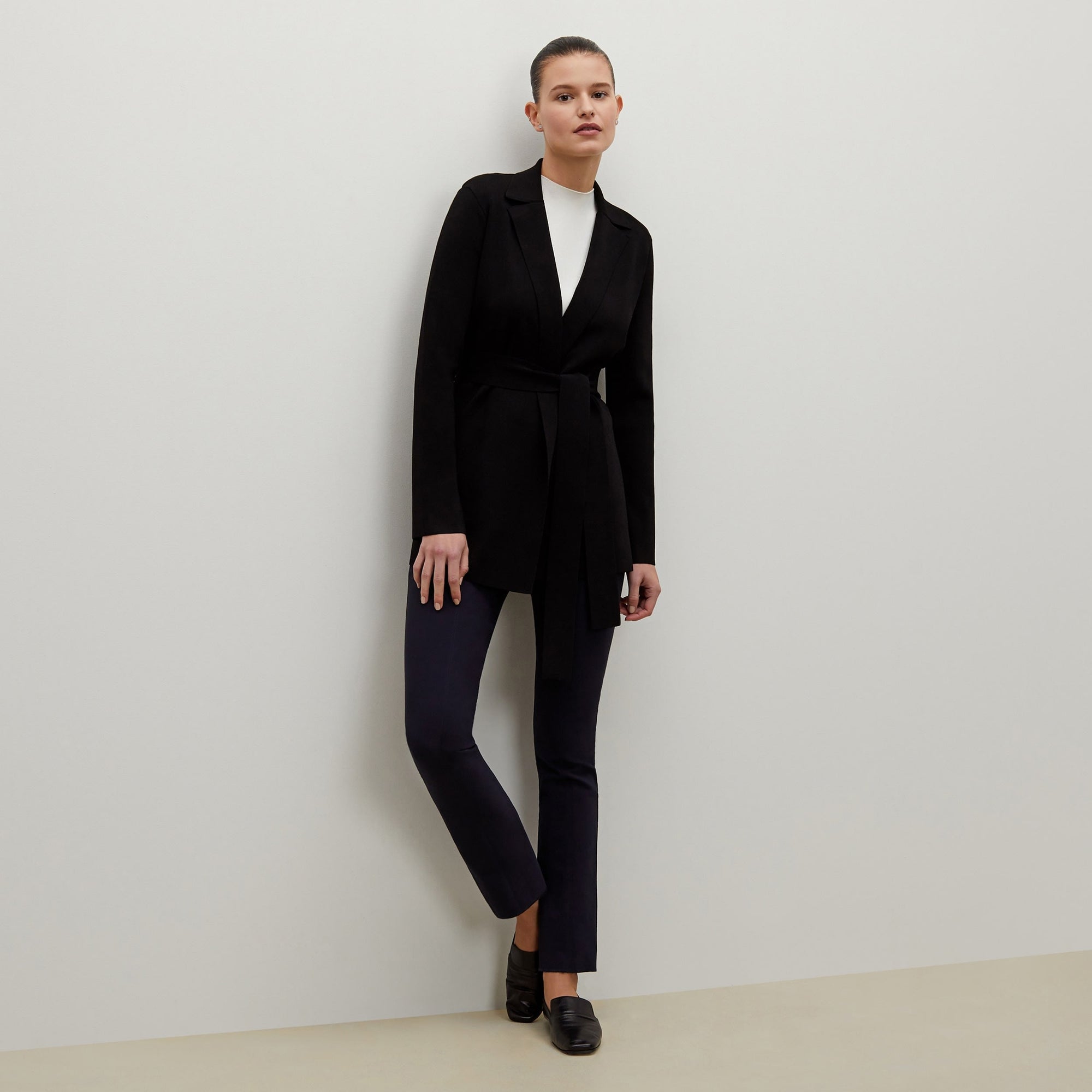 Front image of a woman standing wearing the foster pant in dark navy | Exclude