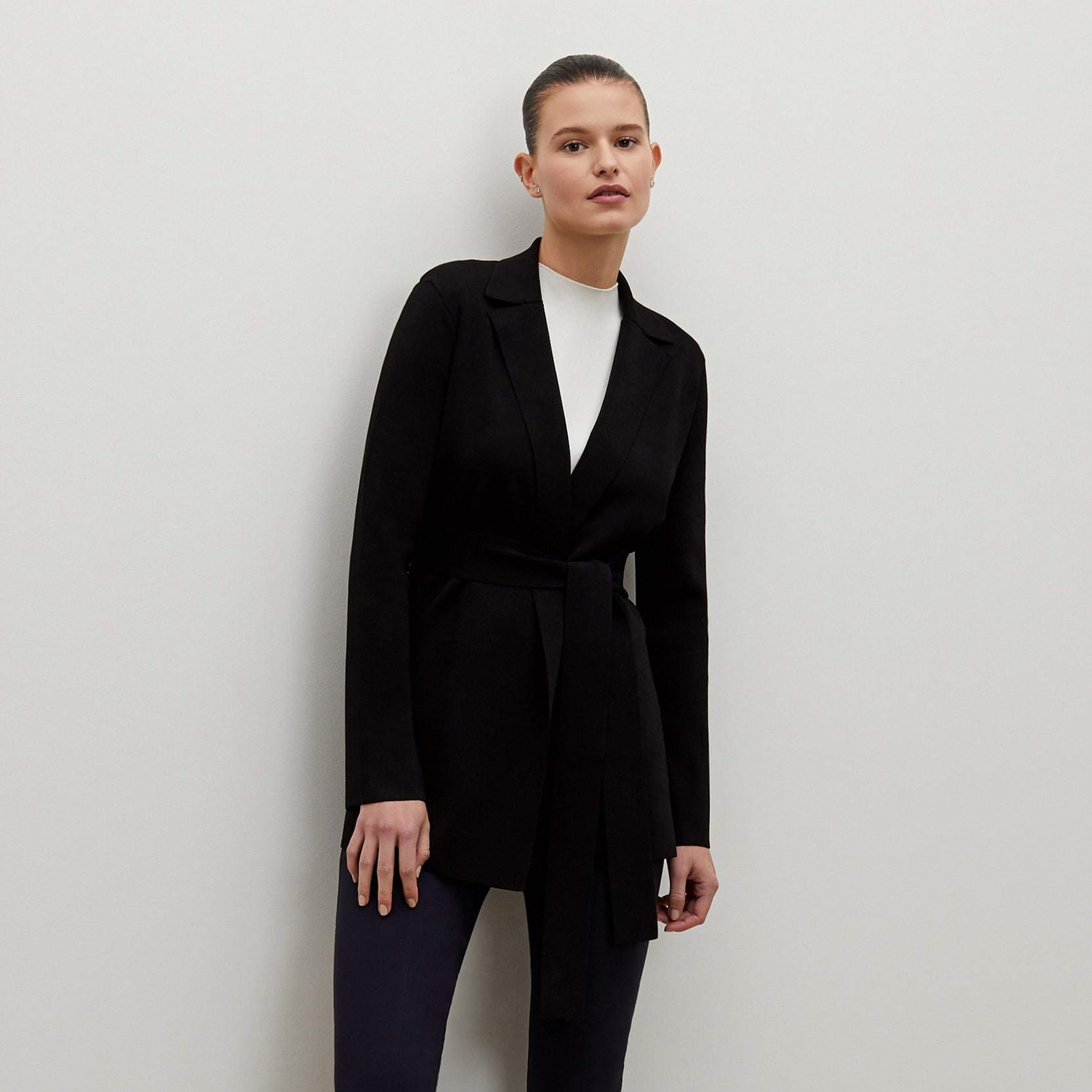 Front image of a woman standing wearing the foster pant in dark navy | Exclude