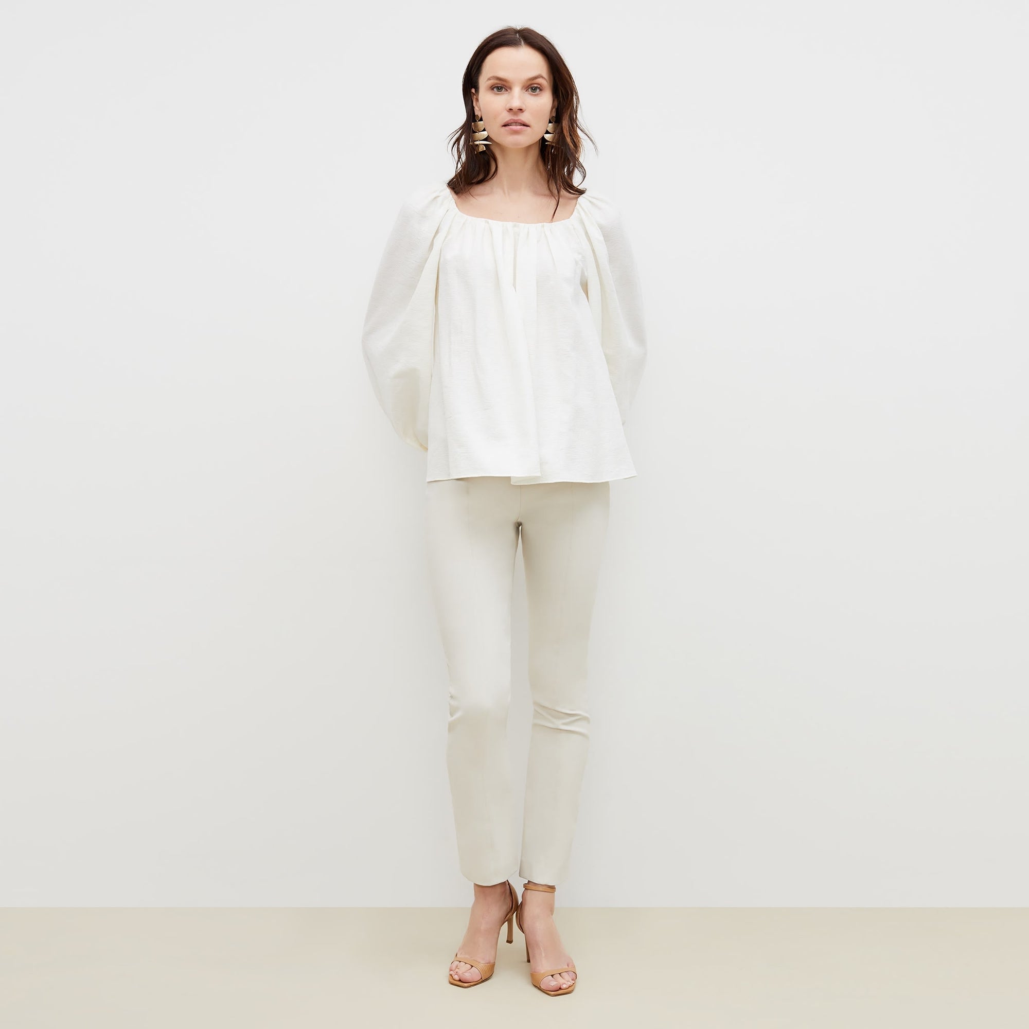 Front image of a woman standing wearing the foster pant in bone | Exclude