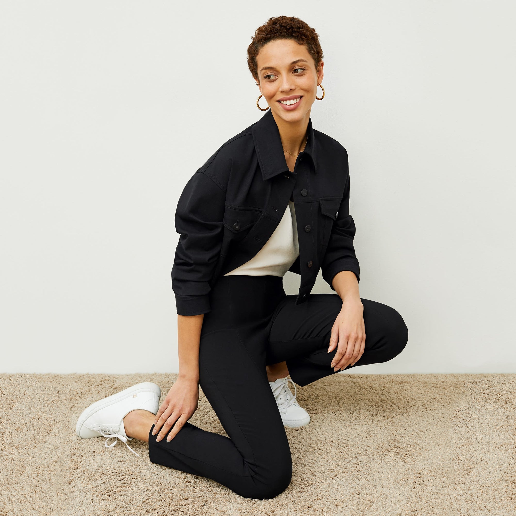 Side image of a woman standing wearing the foster pant in black | Exclude