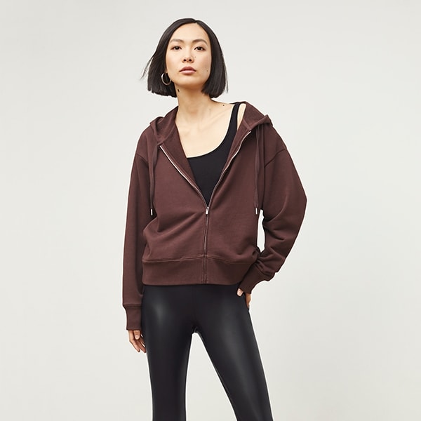 Front image of a woman standing wearing the Harrington Leather—Vegan Leather in Black | Exclude