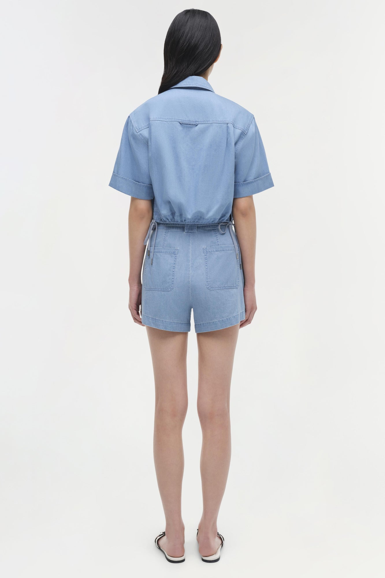 Light blue denim bishop cotton top with short sleeves and belted waist, shown from back view.