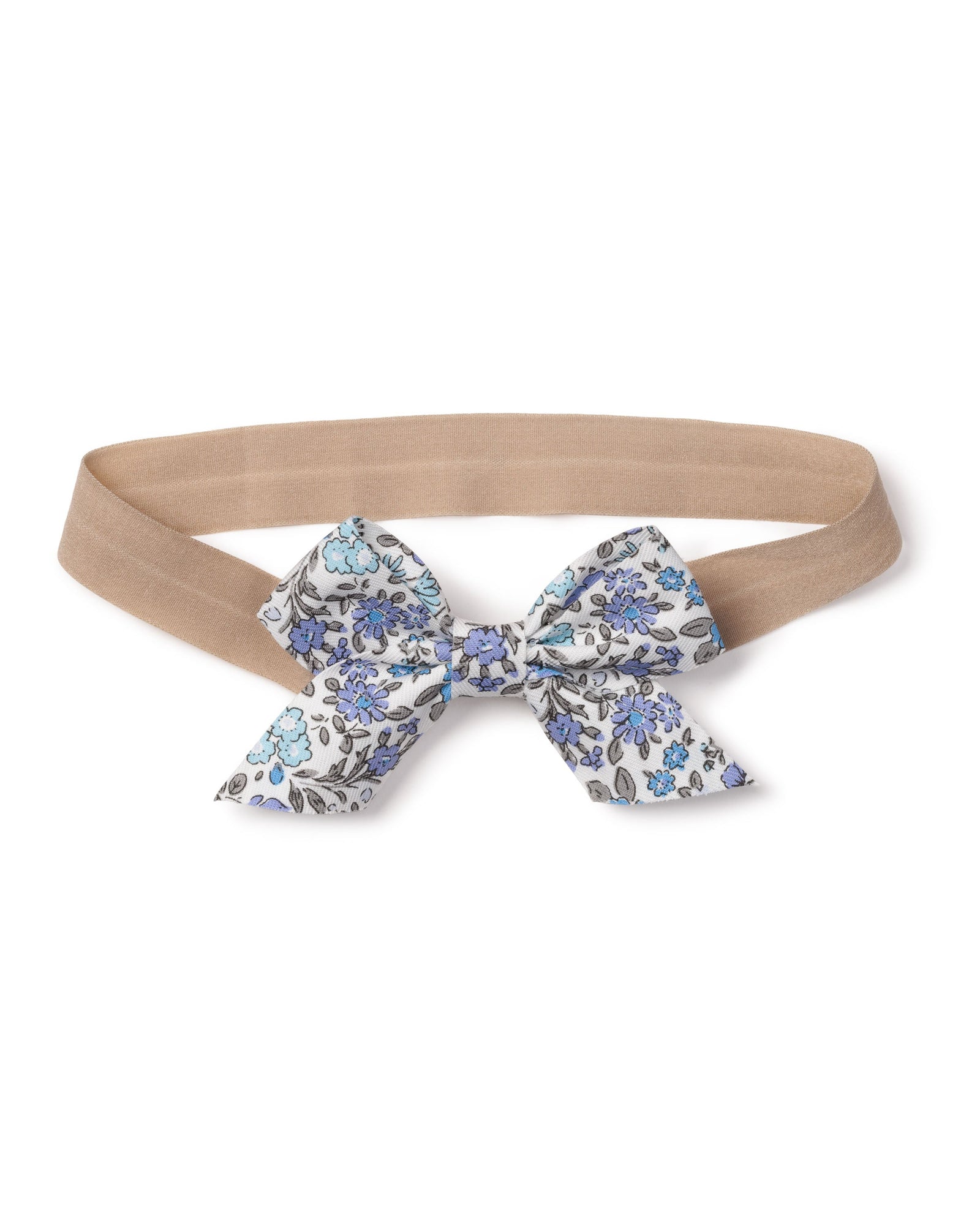 The Girls Twill Hair Bows in Fleur DAzur by Petite Plume feature charming fabrics with an elastic beige band and a decorative bow adorned with a blue and black floral pattern on white. This delightful accessory adds an enchanting touch to any girls ensemble.