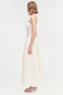 White strapless lace dress with fitted bodice and full skirt, shown from the side on a model.