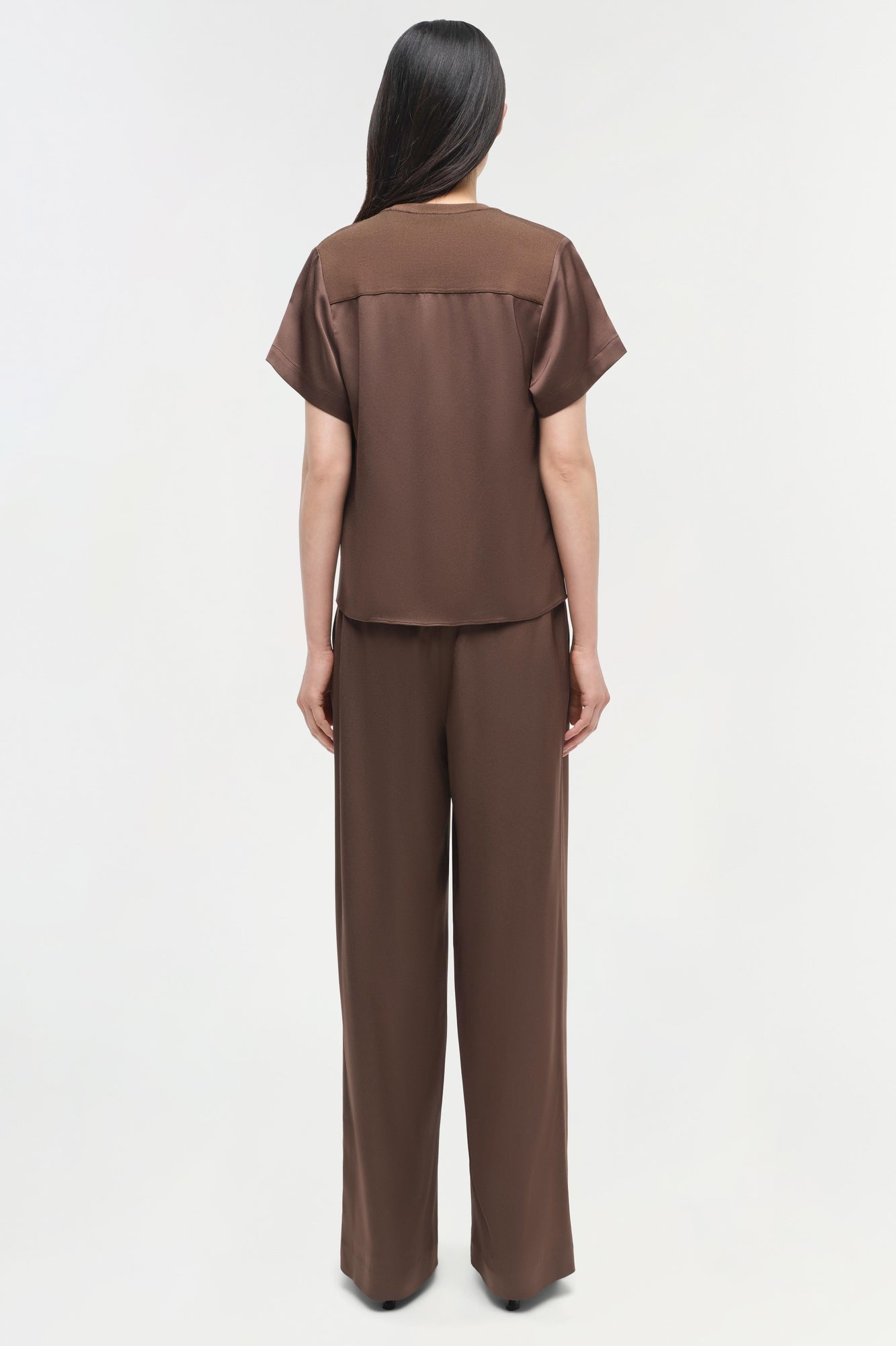 Brown satin t-shirt with short sleeves and matching wide-leg pants, shown on model from back view.