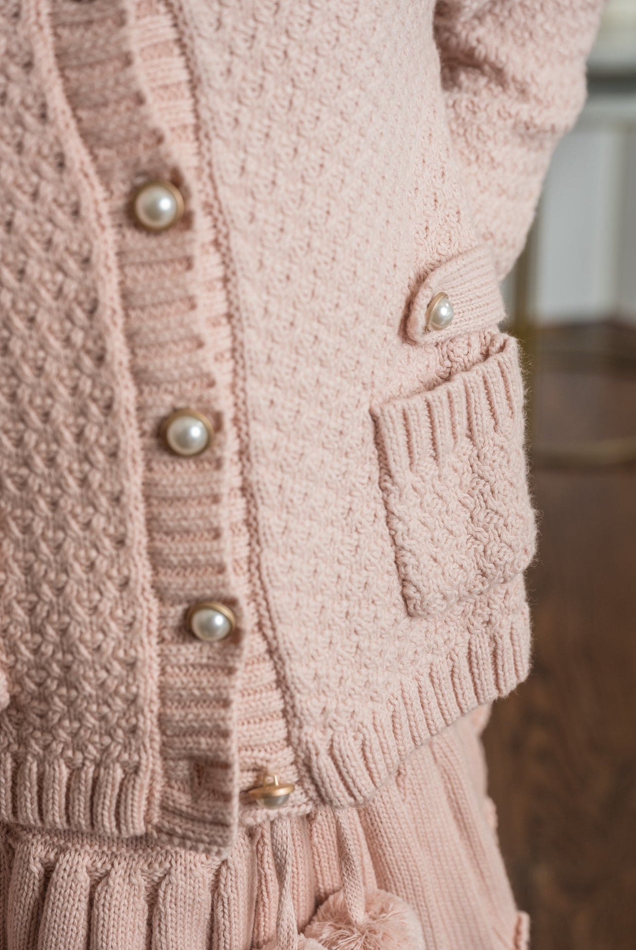 Close up Julie pink knit cotton cardigan showing pearl buttons and textured knit fabric