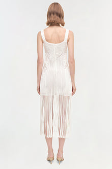 White sleeveless midi dress with vertical ribbed texture and fringe hem detail, shown from back view.