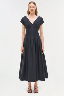 Dark navy cotton midi dress with V-neckline, short sleeves, pleated bodice, and full A-line skirt.