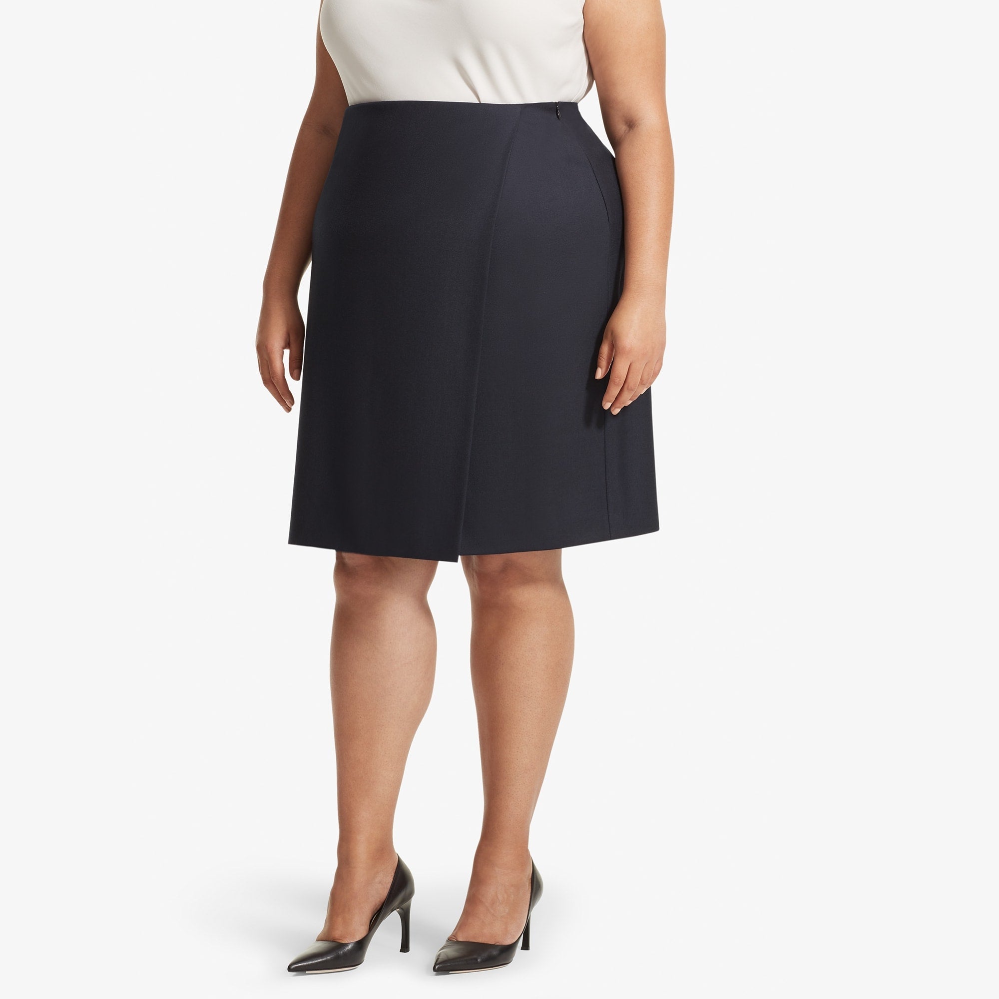 Front image of a woman standing wearing the Logan skirt sharkskin in Ink | Exclude