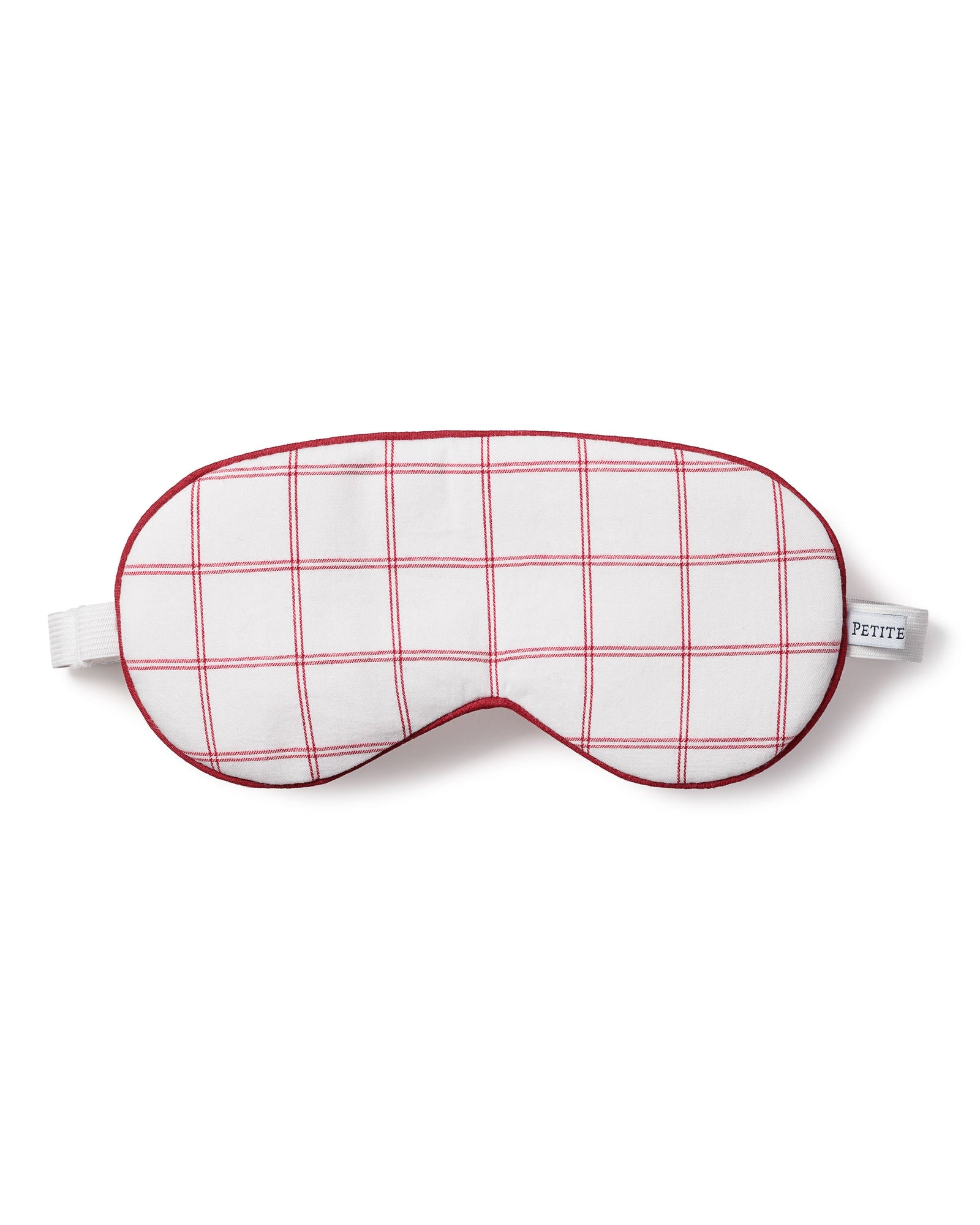 The Adults Twill Sleep Mask in Garnet Tattersall features a red grid pattern with a small “PETITE” label and an elastic strap for a comfortable fit.