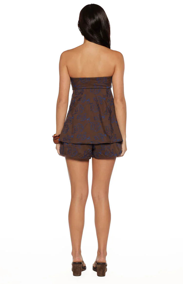 Rear view of brown floral shorts with a relaxed fit and blue pattern