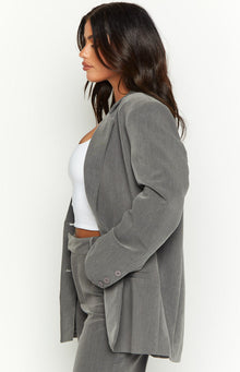 Side profile of a grey oversized blazer with a relaxed fit and three buttons on the sleeve cuff