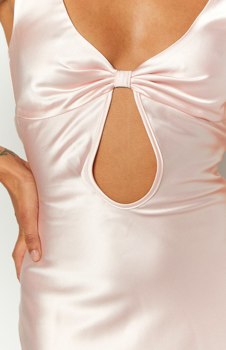 Close-up of the pink satin maxi dress with a bow detail on the bust and a keyhole cutout