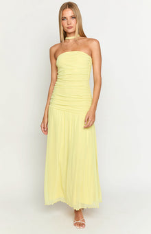 Front view of a yellow strapless maxi dress with a ruched bodice and flowy sheer skirt