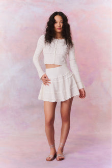 Knitted mini skirt featuring a ribbed yoke, elasticated waistband and a flouncy skirt.