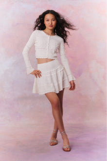 Knitted mini skirt featuring a ribbed yoke, elasticated waistband and a flouncy skirt. 