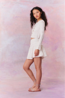 Knitted mini skirt featuring a ribbed yoke, elasticated waistband and a flouncy skirt.