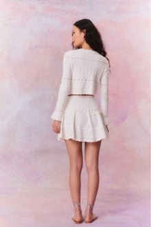Knitted mini skirt featuring a ribbed yoke, elasticated waistband and a flouncy skirt.