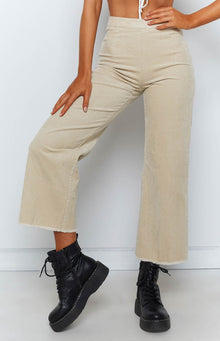 Beige corduroy wide-leg pants with a high waist and raw frayed hem