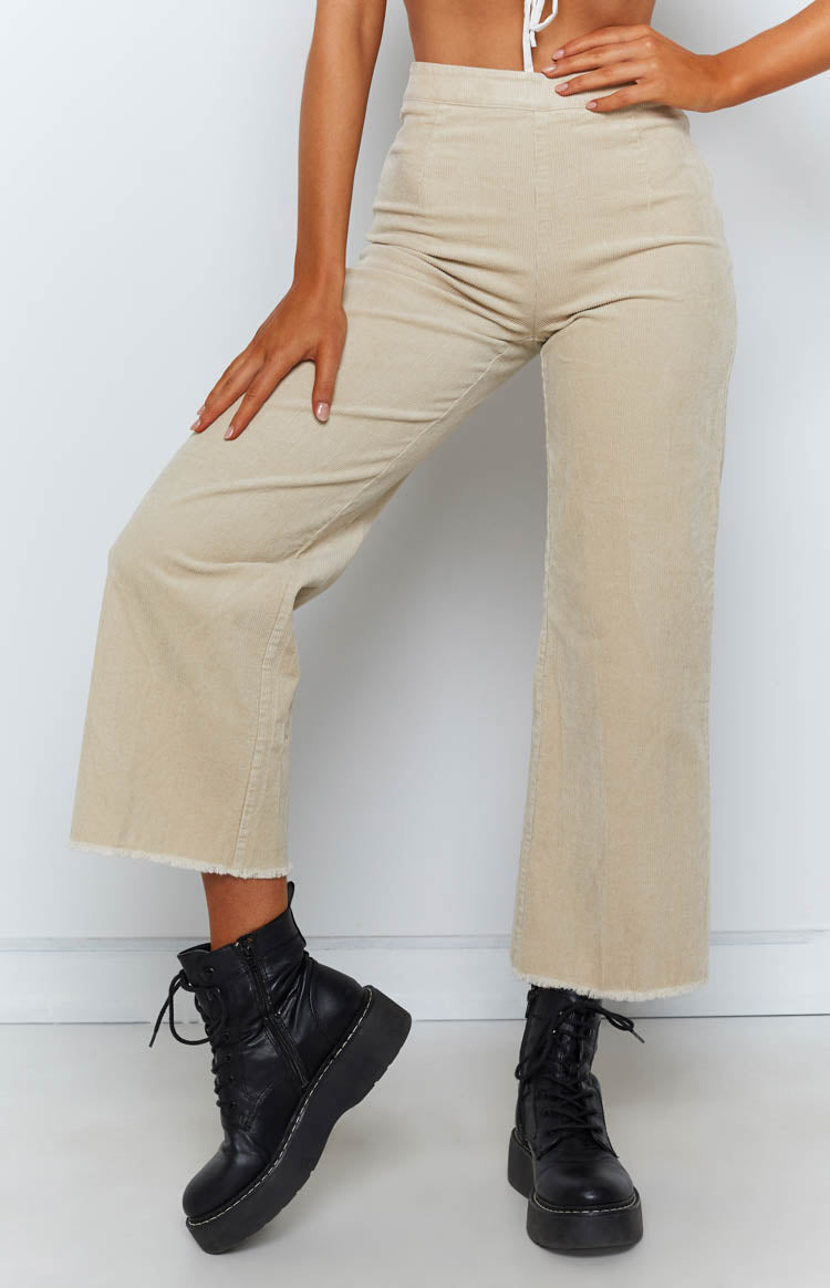 Beige corduroy wide-leg pants with a high waist and raw frayed hem