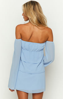 Rear view of a light blue off-shoulder mini dress with a ruched elasticated back bodice and tiered skirt