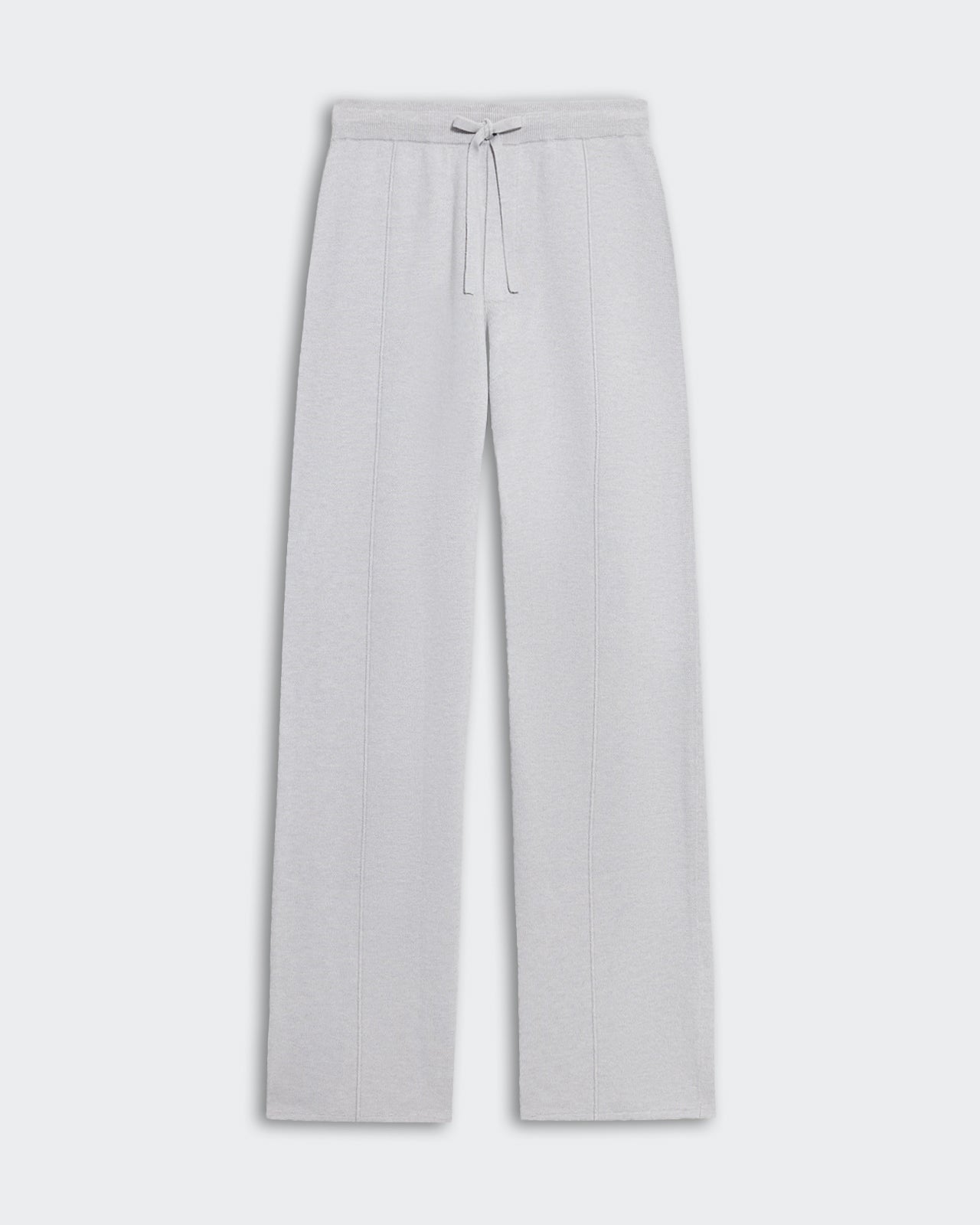 Travel Trouser - Stone, a relaxed-fit pant in light gray fabric with a drawstring waist and subtle vertical seam details, displayed flat on a light background.
