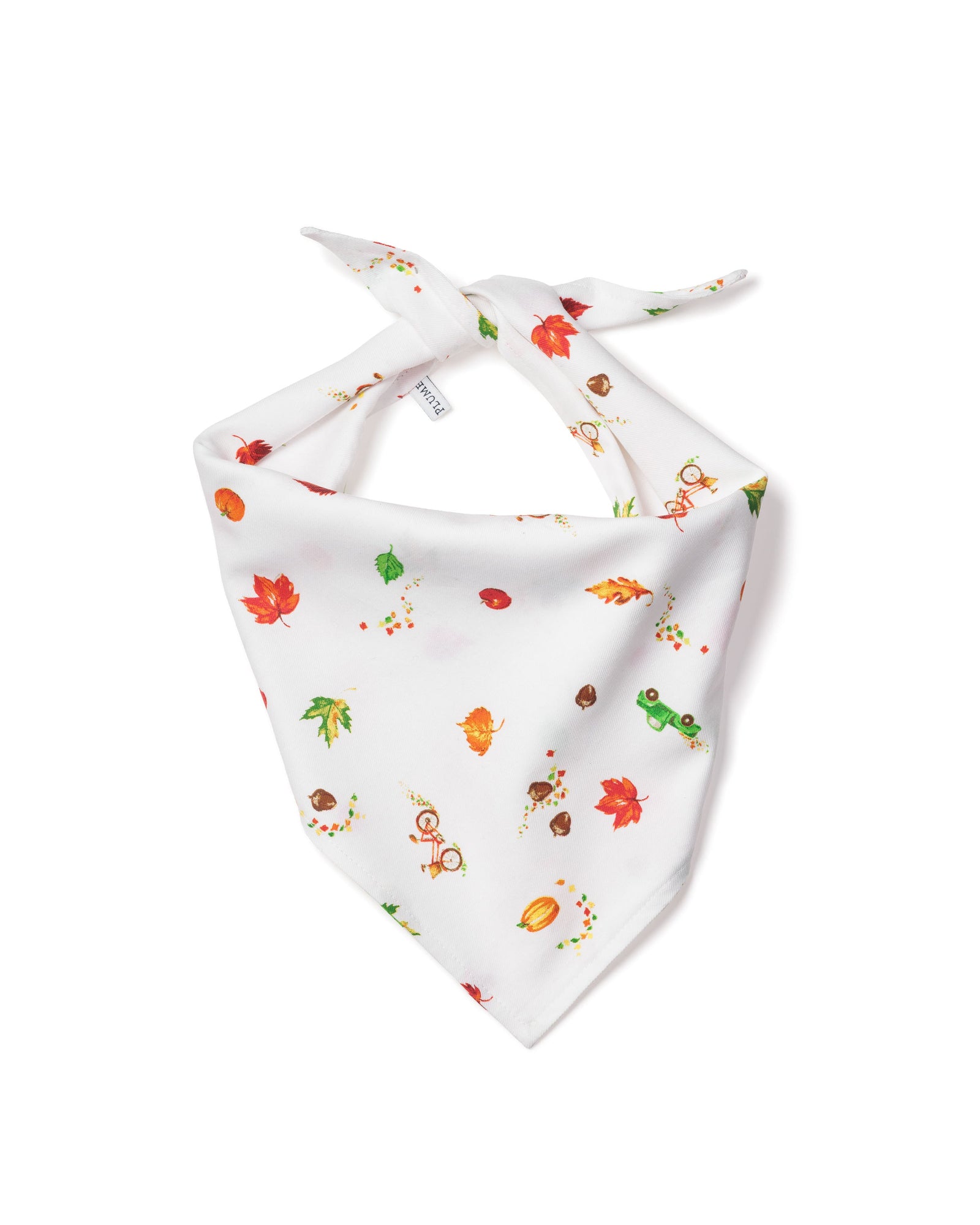 The Twill Dog Bandana in Shades of Autumn features a white base with fall prints—red and orange leaves, acorns, mushrooms, pumpkins, and green caterpillars. It’s arranged with the ties at the top and the point facing down.