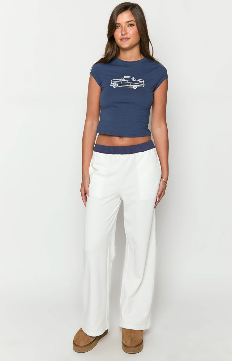 Front view of cream wide-leg track pants with a navy contrast elastic waistband