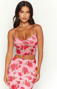 Front view of a pink mesh cami with red floral print, tie-front detail, and scalloped hem