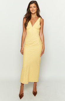 Front view of a yellow broderie anglaise midi dress with a deep V-neck and ruched side details