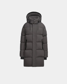 The Rudsak JOELLE - 8124729 Grey is a long, dark grey womens quilted down coat with a hood, front zipper, and snap buttons, made with RDS-certified down, shown against a plain white background.