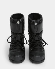 The Rudsak KIKA - L224506 Black women's winter boots feature a puffy design, chunky rubber soles, front laces, and drawstring closures, displayed from the front on a white background.