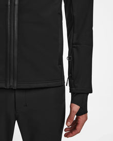 A person wearing the Rudsak TREVOR - 6124519 Black men’s ski jacket, which features advanced technical performance and RECCO rescue technology.