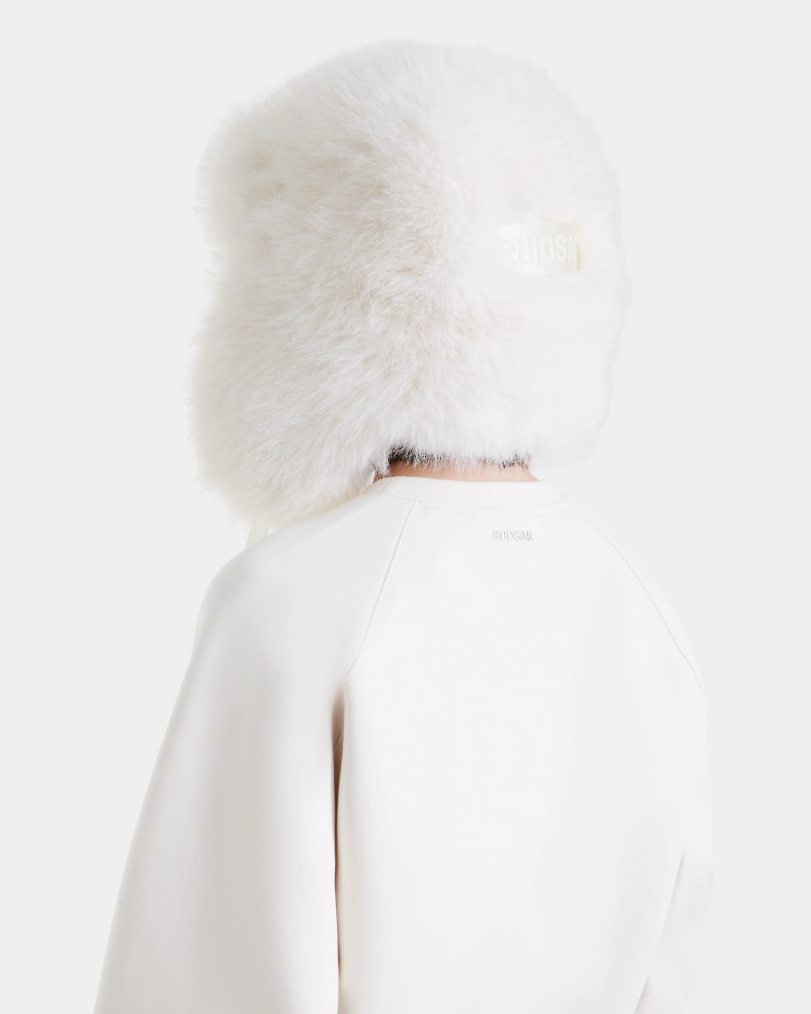 The Rudsak LIDDIE - L525505 Vanilla is a large, fluffy white fur hat that covers most of the head and neck—an effortlessly chic addition to any winter wardrobe.
