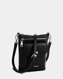 The Rudsak LILA - L325513 Black is a small women's crossbody bag in pebbled leather with silver hardware, a front flap pocket, top zipper closure, adjustable strap, and the RUDSAK logo in silver on the front.