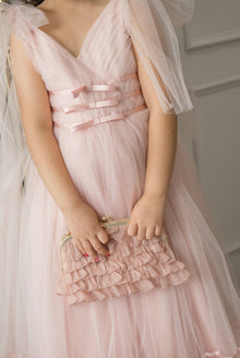 Dusty pink organza ruffle handbag featuring tiered ruffle detailing and gold metal frame, shown held by hand