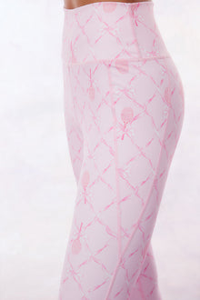Pink active legging with a bow and tennis raquet pattern. 