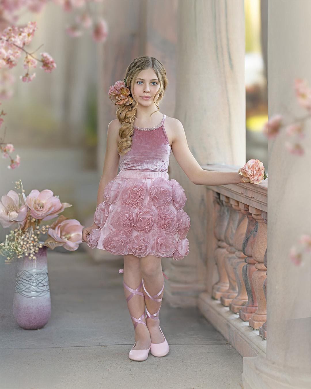 Girls blush pink velvet camisole top with rhinestone trim paired with matching blush pink skirt with flower details styled for a special occasion