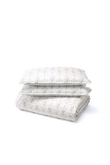 This dreamy ensemble features a delicate blue floral pattern on a pristine white backdrop. Crafted from 100% cotton