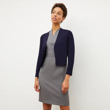 front image of a woman wearing the sant ambroeus jardigan in navy
