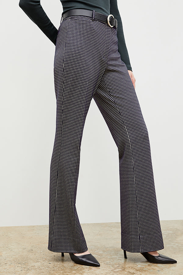 Front image of a woman wearing the horton pant in black and white houndstooth | Exclude