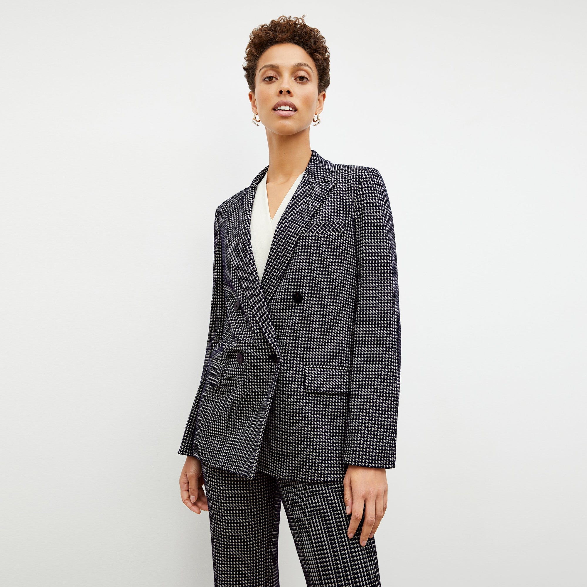 Front image of a woman wearing the horton pant in black and white houndstooth | Exclude