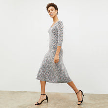 Side image of a woman wearing the Tippy Dress in Brick and Black