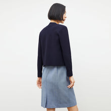 back image of a woman wearing the sant ambroeus jardigan in navy