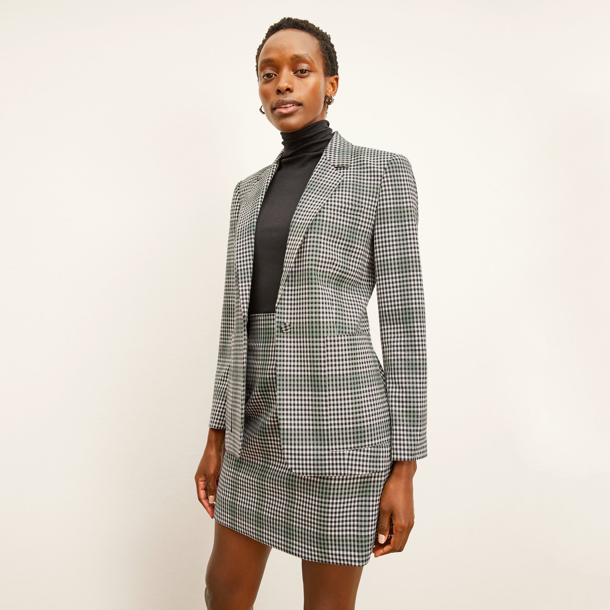 front image of a woman wearing the whitney skirt in check plaid