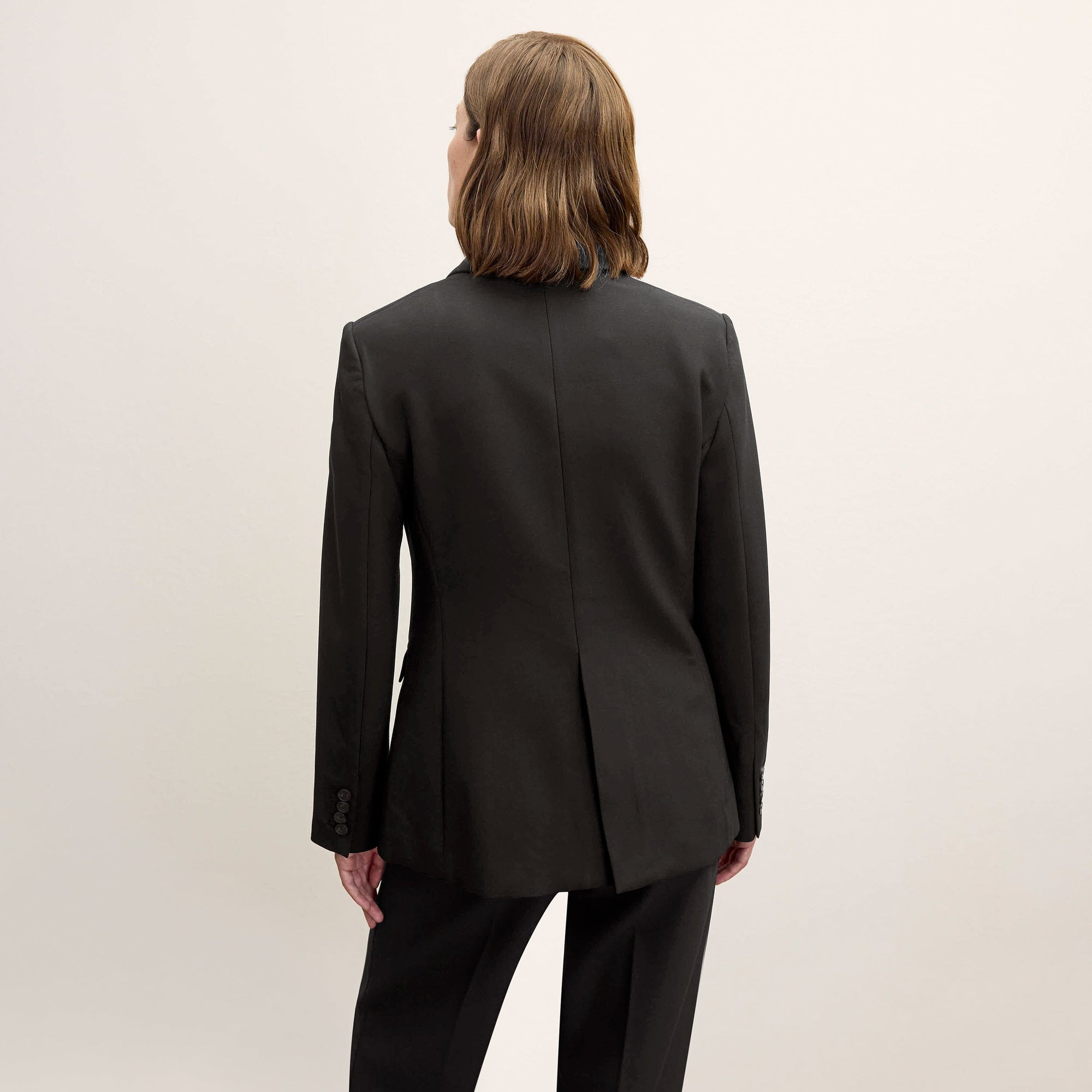 back image of a woman wearing the kati jacket in black
