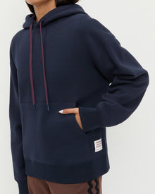 Nova Hoodie in navy cotton and Venus Track Pant in brown cotton.