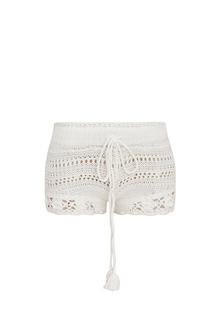 White crochet fabric shorts with a ribbed crochet waistband with a tassel drawcord at center front.