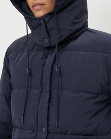 Pippa Puffer Coat in navy nylon and brown wool.