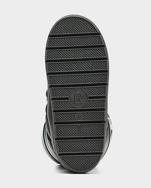 The image shows the bottom sole of the Rudsak TISH - L223508 Pewter womens winter boot, featuring black horizontal grooves, a circular center marked with R and size 34 2/3, and a sturdy platform for added style and comfort.